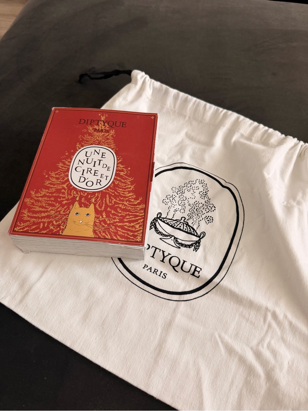 diptyque Une Nuit de Cire et d'Or Card Deck in Red with White Pouch